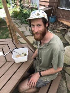 Sam having lunch at a table outside